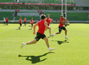 Leroy Cudjoe flings a pass during an England training session