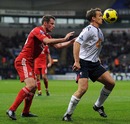 Kevin Davies holds off Jamie Carragher
