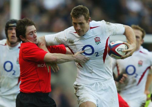 Will Greenwood fends off Shane Williams