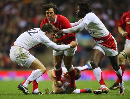 Gavin Henson carries the ball through tacklers