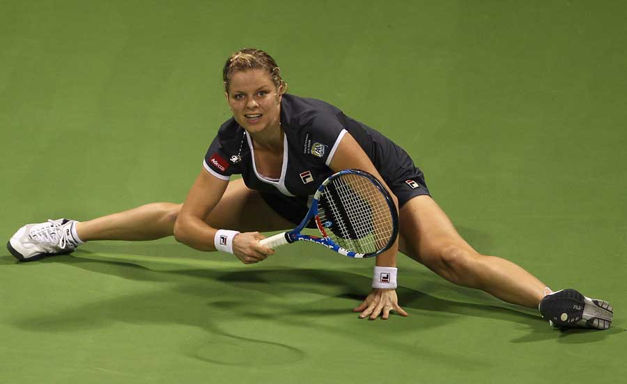 Kim Clijsters stretches to make a return