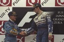 Damon Hill is congratulated by Michael Schumacher