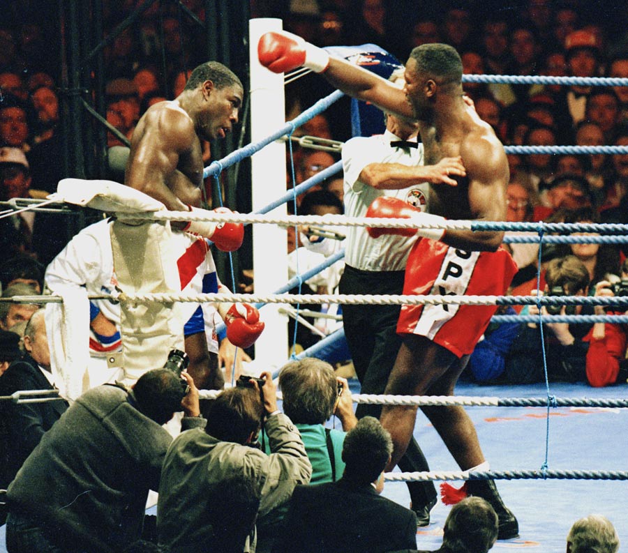 The referee steps in to end the fight between Lennox Lewis and Frank Bruno