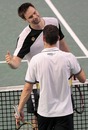 Robin Soderling is congratulated by Michael Llodra after his win