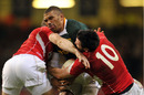 Bryan Habana is foiled by two Welsh defenders