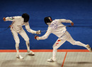 Yin Lianchi lunges at Rusian Kudayev in the Men's Fencing 