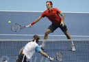 Roger Federer and David Ferrer exchange at the net