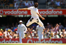 Steven Finn leaps up to celebrate after taking a low catch off his own bowling
