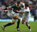 Pierre Spies shrugs off the tackle of Ben Foden