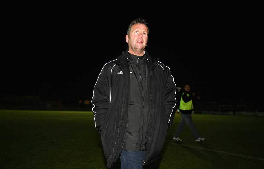 Dave Pace walks across the pitch