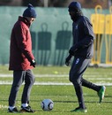 Emmanuel Adebayor and manager Roberto Mancini talk during a training session