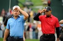 Tiger Woods and Graeme McDowell take off their caps