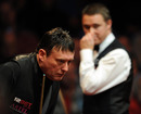 Jimmy White lines up a pot as Stephen Hendry looks on