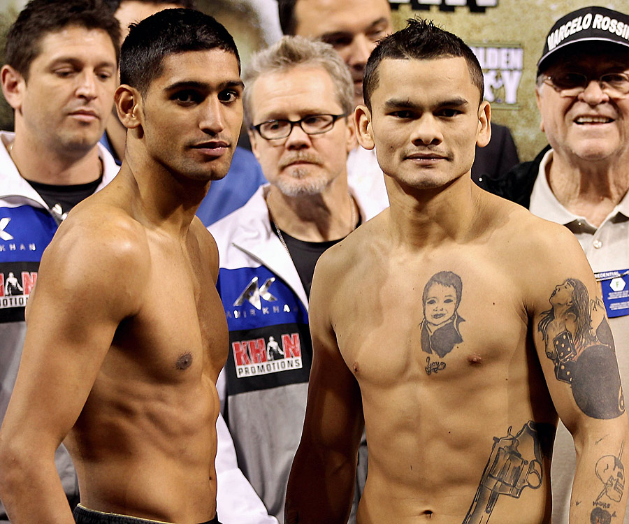 Amir Khan (L) and Marcos Maidana face off at the weigh-in