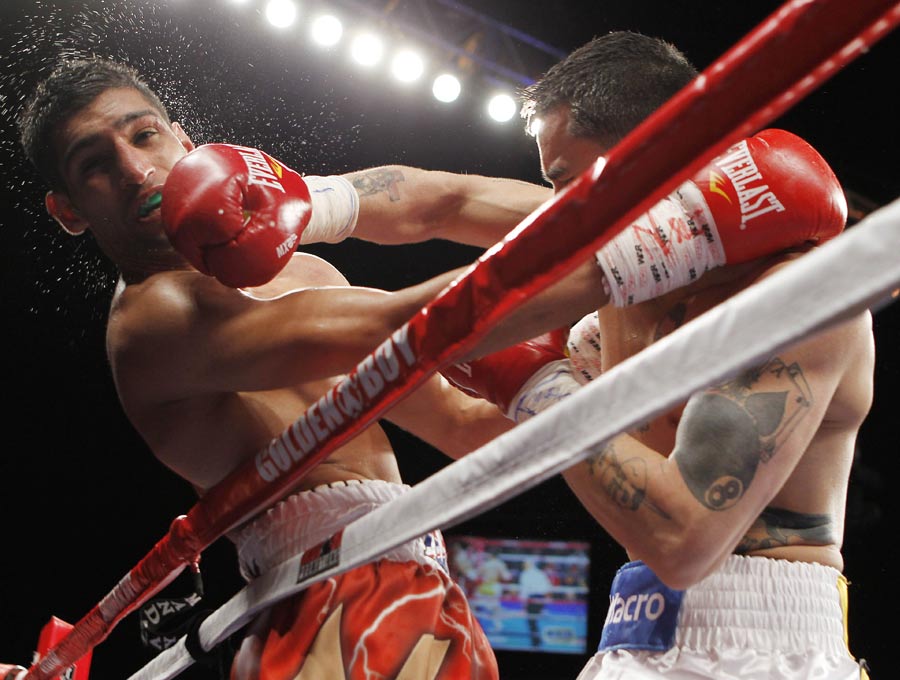 Amir Khan takes a shot from Marcos Maidana in the tenth round