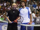 Andre Agassi and Gustavo Kuerten pose for a photo before their friendly match