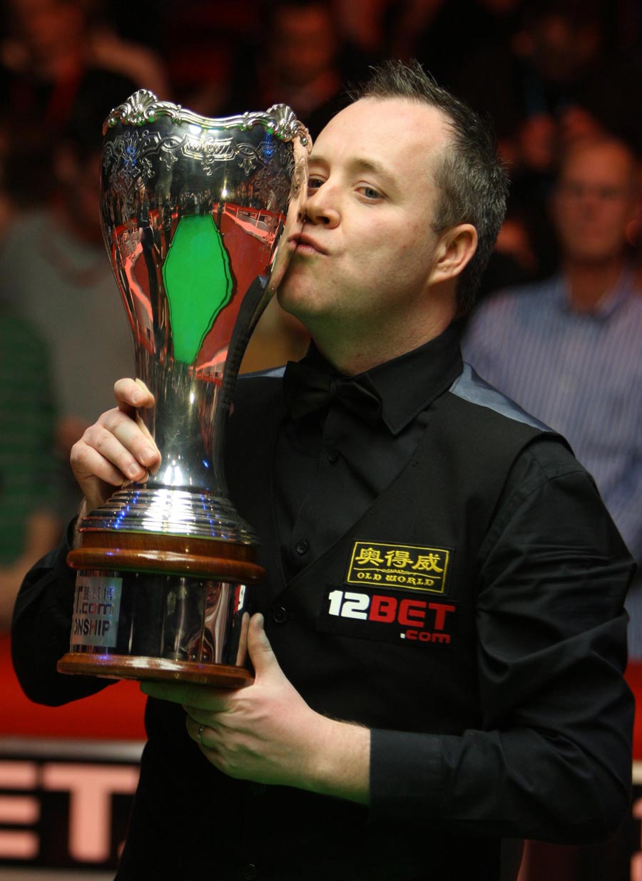 John Higgins kisses his trophy