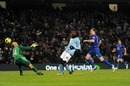 Mario Balotelli chips the ball over Tim Howard