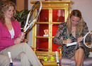 Caroline Wozniacki and Kim Clijsters sign rackets 