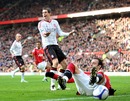 Dimitar Berbatov wins a penalty after a challenge from Daniel Agger
