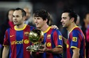 Lionel Messi holds his Ballon d'Or award with his team-mates Andres Iniesta, and Xavi Hernandez