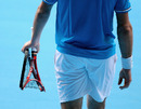 Stanislas Wawrinka holds his smashed racquet