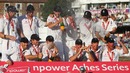 Andrew Strauss of England lifts the Ashes urn as team-mates celebrate victory over Australia
