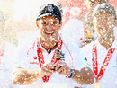 Andrew Strauss holds the Ashes urn under a shower of champagne