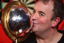 Phil Taylor celebrates after winning the 2009 PDC World Darts Championship against Raymond van Barneveld