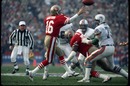 Joe Montana of San Francisco 49ers passes while under pressure from defensive lineman Doug Betters of Miami Dolphins 