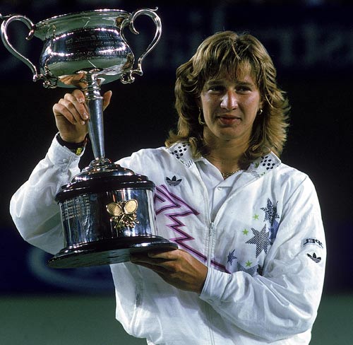 Steffi Graf of Germany raises the trophy after beating Chris Evert to win the 1988 Australian Open