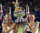Anna Kournikova (L) and Martina Hingis (R) hold their Australian Open trophy 