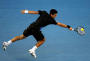 Novak Djokovic reaches a backhand