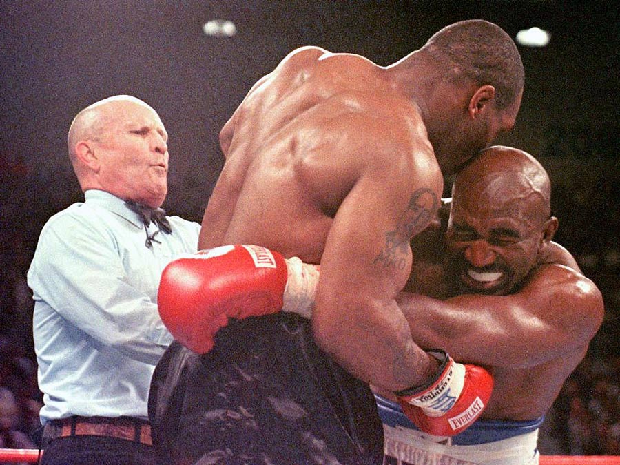 Mike Tyson takes a bite out of Evander Holyfield's ear