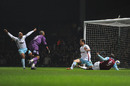 Carlton Cole steers in a goal