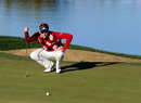Ian Poulter lines up his putt