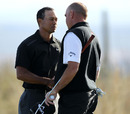 Tiger Woods and Thomas Bjorn share a few words