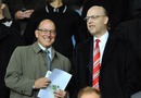 Joel and Avram Glazer enjoy themselves in the stands prior to kick off