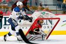 Miikka Kiprusoff of the Calgary Flames has his net toppled over by David Backes of the St. Louis Blues