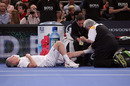 John McEnroe receives treatment on an ankle injury
