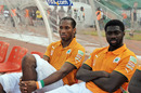 Didier Drogba and Kolo Toure sit on the bench