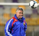 Guus Hiddink plays with a ball during training