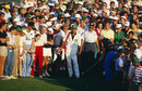 Greg Norman chips into the 18th
