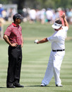 Tiger Woods talks with Pat Perez