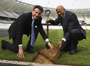Seb Coe and Frankie Fredericks lay the last piece of turf on the Olympic Stadium's field of play