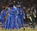 Misbah-ul-Haq and Saeed Ajmal look on as India's players celebrate