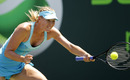 Maria Sharapova stretches to reach a return