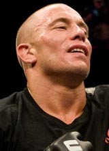 Georges St-Pierre has his arm raised after beating Thiago Alves