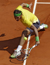 Rafael Nadal slides to play a return