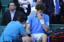 Andy Murray receives treatment on an elbow injury